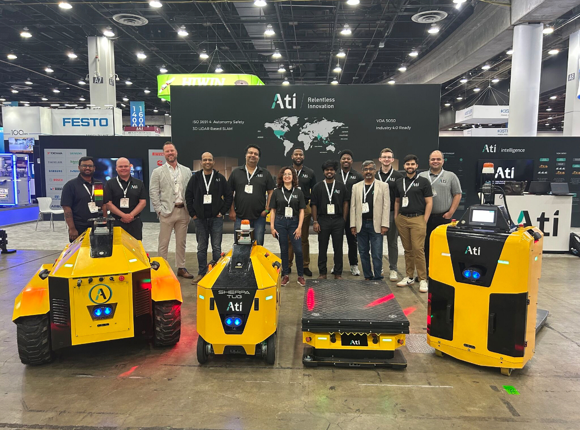 Ati Robotics team with Sherpa AMRs at a trade show