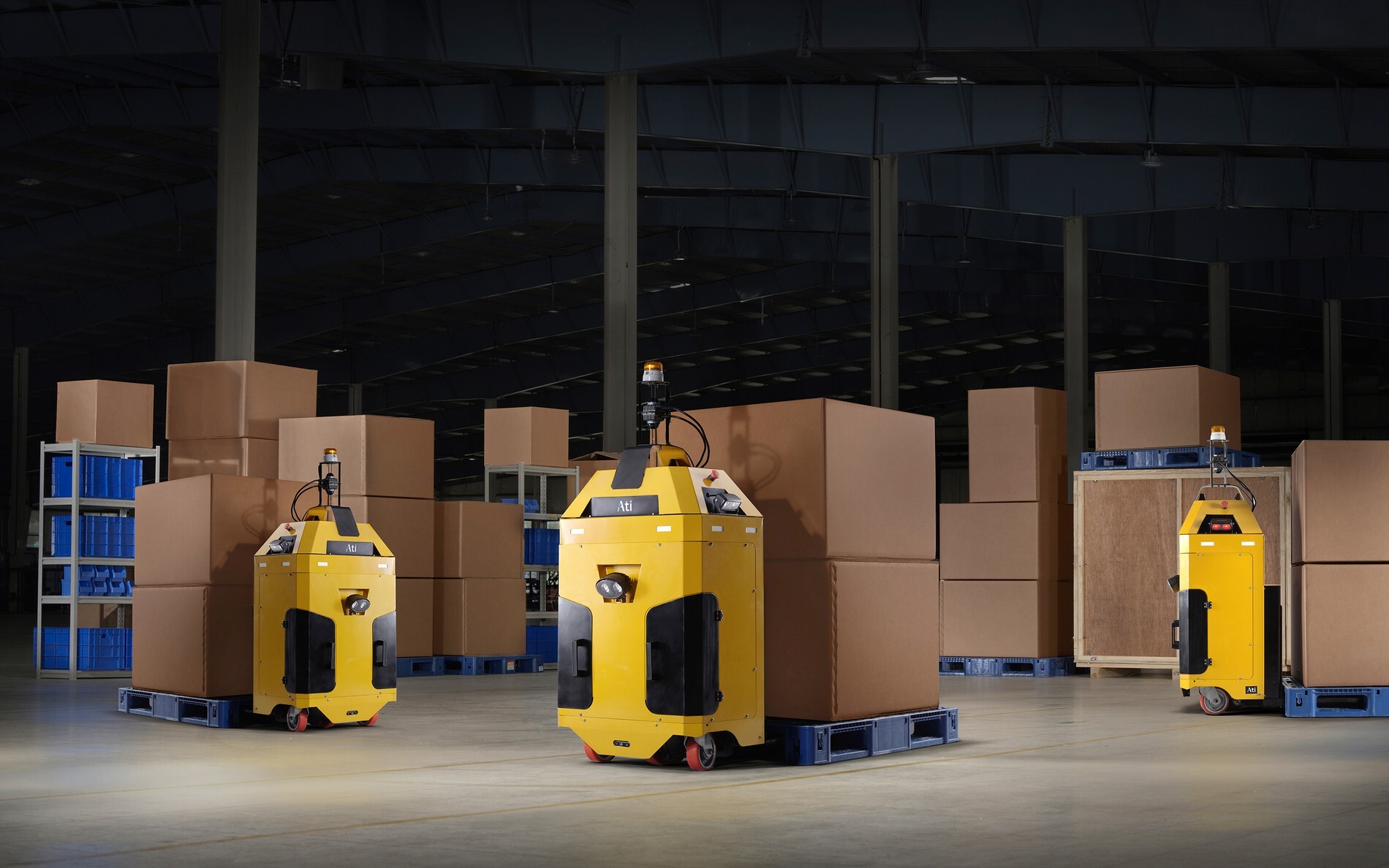Ati Robotics autonomous pallet mover navigating a warehouse floor among staged pallets